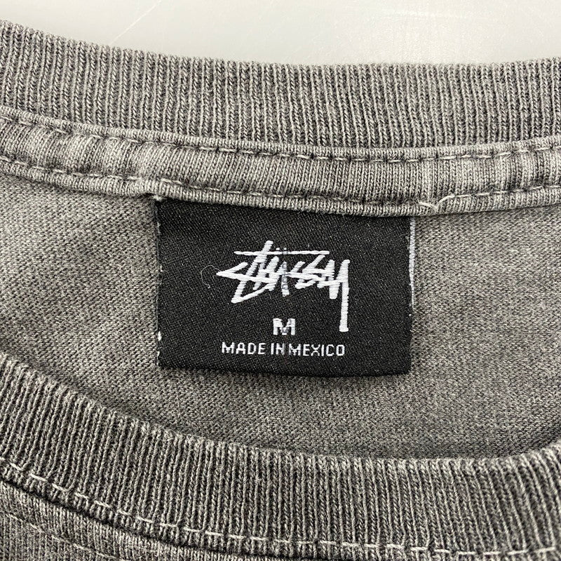 【中古品】【メンズ】 STUSSY ステューシー メキシコ製 CENTER LOGO BACK SURFMAN PRINT SS TEE センター ロゴ バック サーフマン プリント ショートスリーブ Tシャツ トップス 142-260610-kh-07-izu サイズ：M カラー：チャコール系 万代Net店