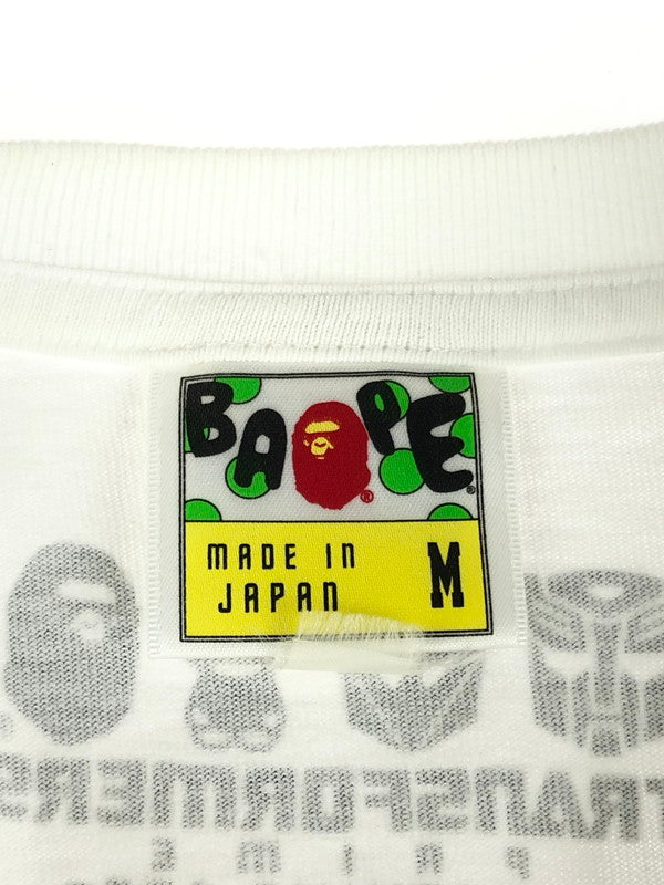 【中古品】【メンズ】 A BATHING APE アベイシングエイプ  × TRANSFORMERS トランスフォーマーズ 別注 コラボ PRIME ABC CYBERTRON MARK TEE BAPEEXCLUSIVE プライム Tシャツ 半袖 トップス 142-240506-kk-1-tag サイズ：M カラー：ホワイト 万代Net店